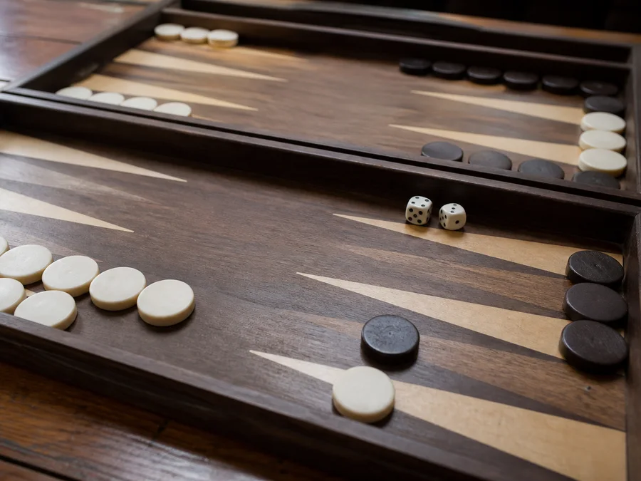 A backgammon blot being hit and sent to the bar, where it must reenter before moving